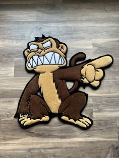 a cartoon monkey pointing at something with its mouth wide open on a wood floor in front of a wooden wall