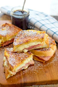 toasted sandwiches with ham and cheese on a cutting board