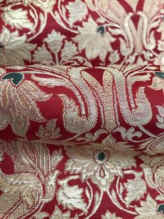 red and gold brocaded fabric with white flowers on the reverse, which is very soft