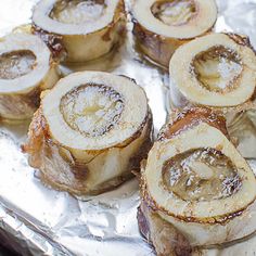 some food is sitting on tin foil and ready to be cooked in the oven,