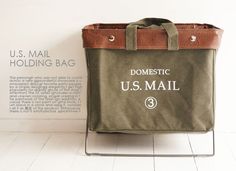 a bag sitting on top of a metal stand in front of a white wall with the words domestic u s mail printed on it