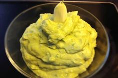 a bowl filled with guacamole on top of a table