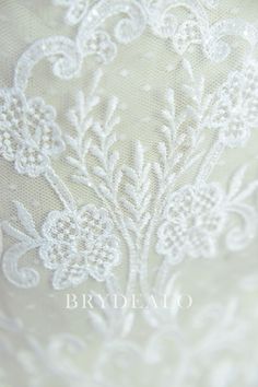 the back of a wedding dress with white lace