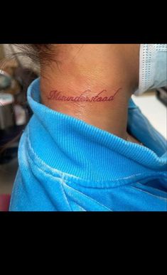 a woman with a tattoo on her neck that says, minnesota road in cursive writing