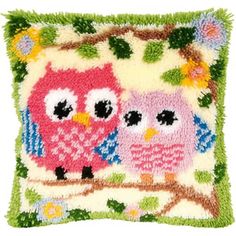 an embroidered pillow with two owls on it