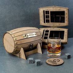 an old fashioned wooden box with two glasses and dices next to it on a table