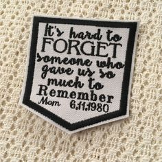 a black and white embroidered patch with the words it's hard to forget someone who gave us so much to remember