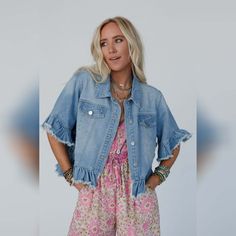 Our Scottie Ruffle Denim Jacket perfectly blends the classic style we love in a jean jacket with updates like a cropped hemline and short sleeves trimmed with a frayed denim flounce. This light blue wash has flap - pockets and silvery stud - buttons with a modern, boxy cut that is just right for so many beautiful seasons. *Due to lighting and differences in monitors, actual colors may vary slightly from what appears online. Model is 5'8" and wearing a size Small/Medium. Approximate measurements: S/M: Bust: 43 1/2", Length (f): 23", Length (b): 25", Sleeve length: 7 1/4" M/L: Bust: 46", Length (f): 24", Length (b): 26", Sleeve length: 7 3/4" 100% Cotton Hand wash cold, lay flat to dry Import Ruffled Denim Jacket, Three Bird Nest, Bralette Outfit, Frayed Denim, Boho Pants, Bird Nest, Sweater Sale, Jacket Design, New Tops