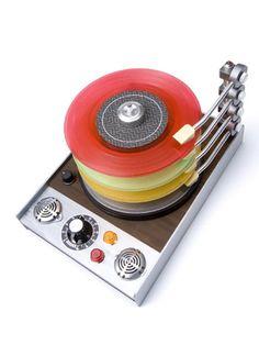 a record player with four different colored discs on it's turntable and controls