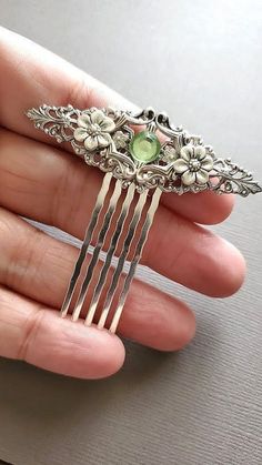 Silver Floral Decorative Hair Comb  This Silver Floral Hair Comb makes a lovely hair accessory for beautiful hair styles. This decorative haircomb has a nice light green crystal center with an array of beautiful flowers. It is great for special occasions like weddings, but can also be great for everyday wear. ☻Color: ~ Silver/Green ☻Link to More Hair Accessories: https://www.etsy.com/shop/FashionCrashJewelry?ref=profile_header&search_query=hair+accessories ☻Link to The ENTIRE SHOP: https://www.e Daphne Bridgerton Hair Accessories, Wedding Accessories Hair Styling Tools, Prom Accessories Hair Styling Tools, Fancy Hair Clip, Victorian Hair Accessories, Green Hair Accessories, Rhinestone Hairpiece, Hair Accessories Green, Hair Accessories Silver