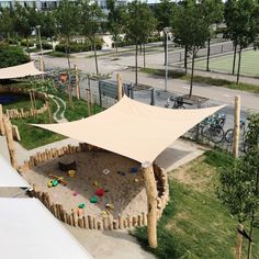 an outdoor play area with sand and toys