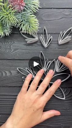 someone is making paper flowers with their hands