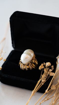 Vintage Mid-Century Pearl & Diamond Cocktail Ring in 18k Yellow Gold This Mid-Century inspired cocktail ring truly shines! A stunning Mabe pearl is the centerpiece of the ring, surrounded by forty (40) round brilliant cut diamonds. The diamonds measure 1.6 mm and weigh .018 carats each.  This ring is sure to make a statement, whether you wear it for a night out or save it as a special heirloom. A timeless addition to any jewelry collection. PRIMARY STONE Stone: Pearl Measurements: 20.32 mm x 13. Luxury High Luster Oval Pearl Ring, Luxury Pearl Ring With Diamond Accents For Anniversary, Luxury High Luster Pearl Ring For Formal Occasions, Luxury Pearl White Pearl Ring With Diamond Accents, Luxury Oval Pearl Ring, Luxury Gold Rings With Pearl Drop, Luxury Pearl Drop Ring For Formal Occasions, Luxury Pearl Ring With Diamond Accents For Wedding, Luxury Pearl Ring For Evening