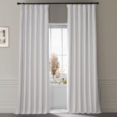 a white curtain hanging in front of a window