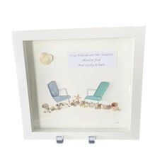 a white frame with two chairs and shells in it