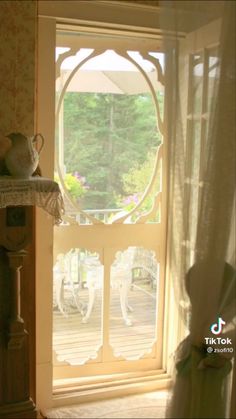 an open window in a room with white curtains