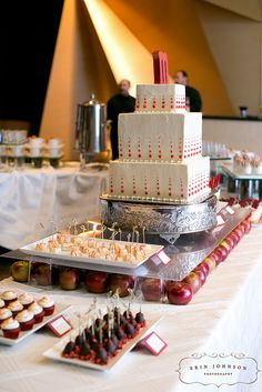 a table topped with lots of food and desserts on top of eachother