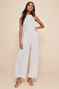 Shake up your event-ready looks with a picture-perfect outfit like the Lulus Flawless Mindset Ivory Satin Plisse Tie-Back Jumpsuit! Plisse-pleated woven satin shapes this elevated jumpsuit with a modified halter neckline (with back loop-button closures) and a fitted bodice with a smocked, banded waist. Relaxed, wide pant legs end at full length hems. Turn around to reveal a back cutout with a tying sash bow for an extra-femme finish! Elastic at back. Fit: This garment fits true to size. Length: Fitted Jumpsuits And Rompers For Wedding Guest In Spring, Sleeveless Jumpsuits And Rompers For Wedding Guests In Summer, Sleeveless Jumpsuits And Rompers For Summer Wedding, Chic Sleeveless Jumpsuit For Wedding Guest, Chic Sleeveless Jumpsuit For Wedding, Sleeveless Jumpsuits And Rompers For Wedding Guest, Chic Sleeveless Jumpsuits And Rompers For Wedding, Chic White Jumpsuit For Event, Chic White Jumpsuits And Rompers For Wedding Guest