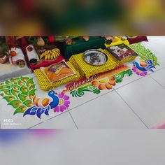 the table is covered with colorful decorations and pictures on it, along with other items