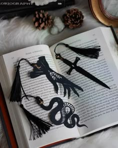 an open book with some black decorations on it