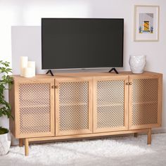 a flat screen tv sitting on top of a wooden cabinet