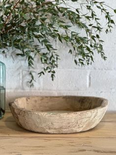 a wooden bowl sitting on top of a table