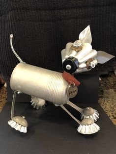 a metal dog sculpture sitting on top of a table