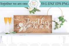 a wooden sign that says together we are one with flowers and greenery on it