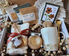 a gift box filled with tea, candles and other items for someone's special occasion