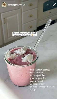 a pink smoothie in a glass with a spoon