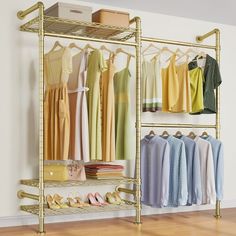 an organized closet with clothes and shoes hanging on gold shelve racks in front of a white wall