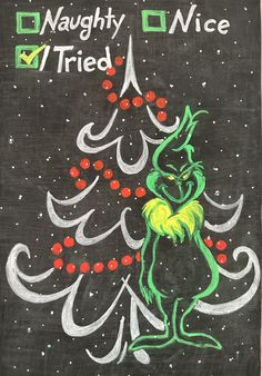 a chalk drawing of a cat in front of a christmas tree