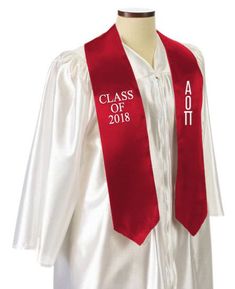 a green and white graduation stole on a mannequin