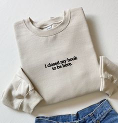 Embroidered I Closed My Book To Be Here Sweatshirt, Embroidered Book Sweatshirt, Bookish Gifts, Gift For Reader, Book Sweater, Book Gifts Material: 80% ring spun, combed cotton (softest, most durable and most environmentally friendly cotton around 20% polyester. This sweatshirt features super high quality embroidery, meaning your sweatshirt will last and last, wash after wash. This way you can wear it as many times as you wish and reduce wastage at the same time. Soft cotton faced fabric. Stylish fit and lining. Set-in sleeves. Taped neck. Ribbed collar cuffs and hem. Twin needle stitching. Worldwide Responsible Accredited Production (WRAP) certified production. Supersoft brushed inner fabric. Fit: Slightly oversized, stylish fit. The embroidery on this sweatshirt can be applied to other g Book Shirts Aesthetic, Book Club Merch, Bookish Sweaters, Cute Embroidered Sweatshirt, Book Hoodies, Book Apparel, Bookish Clothes, Book Sweatshirts, Bookish Sweatshirts