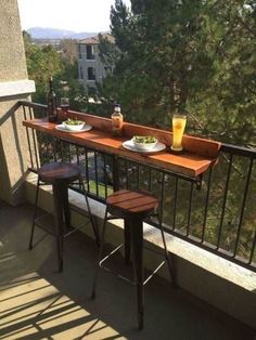 two plates of food and drinks on a balcony