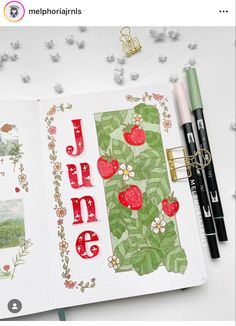 an open notebook with the word june written in red and green on it, surrounded by other items