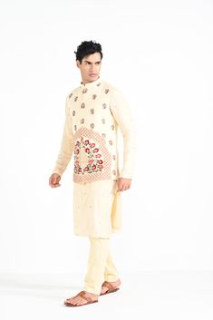 Rajasthani floral Hand embroidered nehru kurta set made in cream bamberg raw silk. Paired with cream slim fit Pant Pajama. Color of the actual garment may vary due to lighting conditions during the shoot.

Size Chart For Men





	
	
					Men's Size Chart
		

		
		
						
				Size Chart For Men
				Custom Size Measurement Guide
			
			
				
				
				Custom Size Measurement Guide
1. Take your measurements at ease…don’t hold your breath!
2. Be a little generous with the measurements. It’s always e Off White Raw Silk Straight Kurta Set, Cream Cotton Silk Kurta With Traditional Drape, Designer Cream Kurta For Navratri, Designer Wear Cream Kurta For Navratri, Off-white Churidar With Straight Kurta, Festive Cream Cotton Silk Traditional Wear, Cotton Silk Nehru Jacket With Floral Embroidery For Diwali, Bollywood Cotton Bandhgala With Floral Embroidery, Festive Off-white Chanderi Kurta