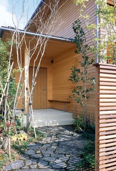 a wooden building with a stone walkway leading to it