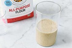 an all - purpose flour is sitting next to a blender