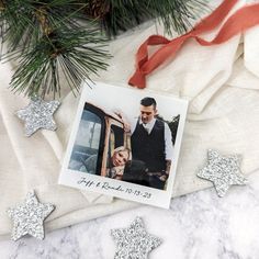 an ornament with a photo on it next to christmas decorations