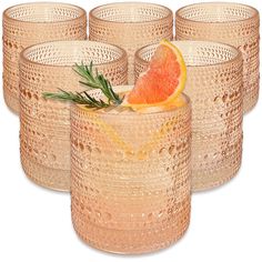 six glasses with grapefruit and rosemary garnish