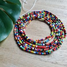 This colorful waistbead was made with multicolored glass seed beads.Waistbead length: 50 inches Strung on strong, cotton cord with 2 clear anchor beads (for adjustment) and 2 knots. Tie on, permanent waistbeads. Waist beads have been worn for centuries in African tradition, and the uses are endless. From adornment and weight management, all the way to signs of maturity and femininity, the diversity of waist beads make them appealing pieces of jewelry to own. They are generally worn under a garme Multicolor Waist Beads For The Beach, Multicolor Waist Beads For Beach, Multicolor Round Waist Beads For Beach, Multicolor Beaded Waist Beads For Summer, Adjustable Multicolor Waist Beads For Summer, Multicolor Waist Beads For Summer Festival, Colorful Waist Beads For Summer, Adjustable Multicolor Waist Beads With Large Beads, Colorful Heishi Waist Beads