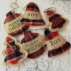 four christmas ornaments with the words merry christmas written in green and red plaid on them