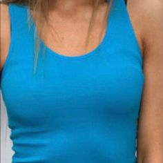 F&F One Size Turquoise Racer Back Tank. Fabric: 95% Nylon 5% Spandex Blue Scoop Neck Tank Top For Spring, Basic Blue Tank Top, Blue Seamless Top For Spring, Blue Seamless Tops For Spring, Blue Scoop Neck Summer Tops, Turquoise Fitted Tank Top, Basic Blue Tank Top For Summer, Turquoise Tank Top, Neon Tank Top