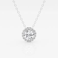 A diamond with a fine halo is better than none! This beautiful round lab grown diamond pendant is encircled with tiny shimmering smaller diamonds, to create a halo effect. Suspended by a delicate gold chain that slides through. Luxury Diamond Necklace With Round Pendant And Cable Chain, Round Lab Grown Diamond Necklace With Halo Setting, Round Halo Setting Necklace With Lab Grown Diamond, Diamond White Necklace With Halo Setting And Round Stone, Round Necklace With Halo Setting And Lab Grown Diamond, Sterling Silver Diamond White Necklace With Halo Design, White Diamond Necklace With Round Cut Halo Design, Dazzling Solitaire Necklace With Round Pendant And Halo Setting, Dazzling Cubic Zirconia Diamond Necklace With Halo Design