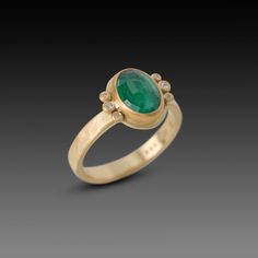 A luscious rose cut, oval emerald is wrapped in warm 22k gold and nestled between two diamond trios. Set on a hammered, 3mm 18k gold band. This ring would make a stunning engagement ring, or a special addition to your jewelry collection. Emerald measures approximately 3/8 inch x 7/16 inch. Matte finish. Oval Emerald Ring With Single Cut Diamonds, Oval Emerald Ring With Rose Cut Diamonds, Oval Gold Emerald Ring With Rose Cut Diamonds, Heirloom Oval Emerald Ring With Single Cut Diamonds, Oval Emerald Ring With Rose Cut Diamonds In Gold, Oval Emerald Ring With Rose Cut Diamonds For Anniversary, Oval Emerald Ring With Single Cut Diamonds For Anniversary, Oval Rose Cut Diamond Rings For May Birthstone, Anniversary Oval Emerald Ring With Rose Cut Diamonds