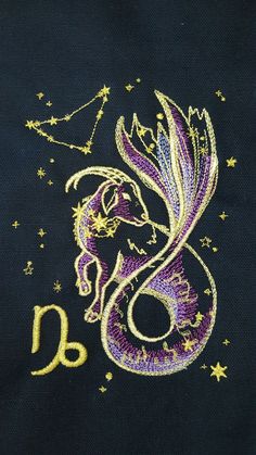 the zodiac sign is depicted on a black t - shirt with gold and purple sequins