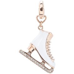 an ice skate charm with crystals on the bottom and gold trimmings, set against a white background