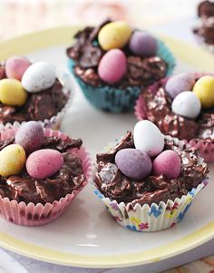 several cupcakes decorated with chocolate and candy eggs