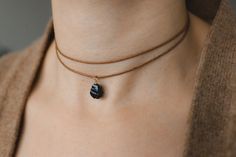 💎Black obsidian choker necklace 🌿Meaning: protection grounding transformation ✨This is a natural obsidian necklace in which the gemstone is wrapped with a high-quality wire. Fully adjustable with a sliding bead on a high-quality cotton cord.The stone is hand-picked and carefully crafted into a pendant. 🎨Colour ribbon / wire  Three different colours are available for the waxed cotton cord: -Beige (natural colour) -brown -black and two colours for the wire:  -Gold (gold-filled) -Silver (sterling silver) 🖤Natural raw obsidian Size: 8-10mm PLEASE take into account the natural variations of the crystals. As this is a natural product, size and colour may vary. Each stone is unique, just like you! Each piece will therefore differ from the picture.  ☀️ VISIT OUR SHOP: ☀️ https://www.etsy.com/s Raw Obsidian, Choker Handmade, Obsidian Necklace, Hand Wound, Choker Black, Perfect Gift For Girlfriend, Gemstone Choker, Natural Jewelry, Black Choker